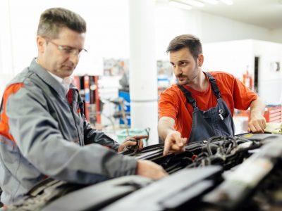 Car mechanic fixing a car Car mechanic fixing a car