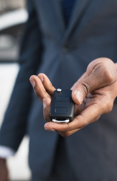 Car sale concept. Man hand giving car key